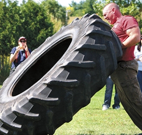 The Tire-Flip: A "Strongman" event. Man flipping a tire in the Strongman event.